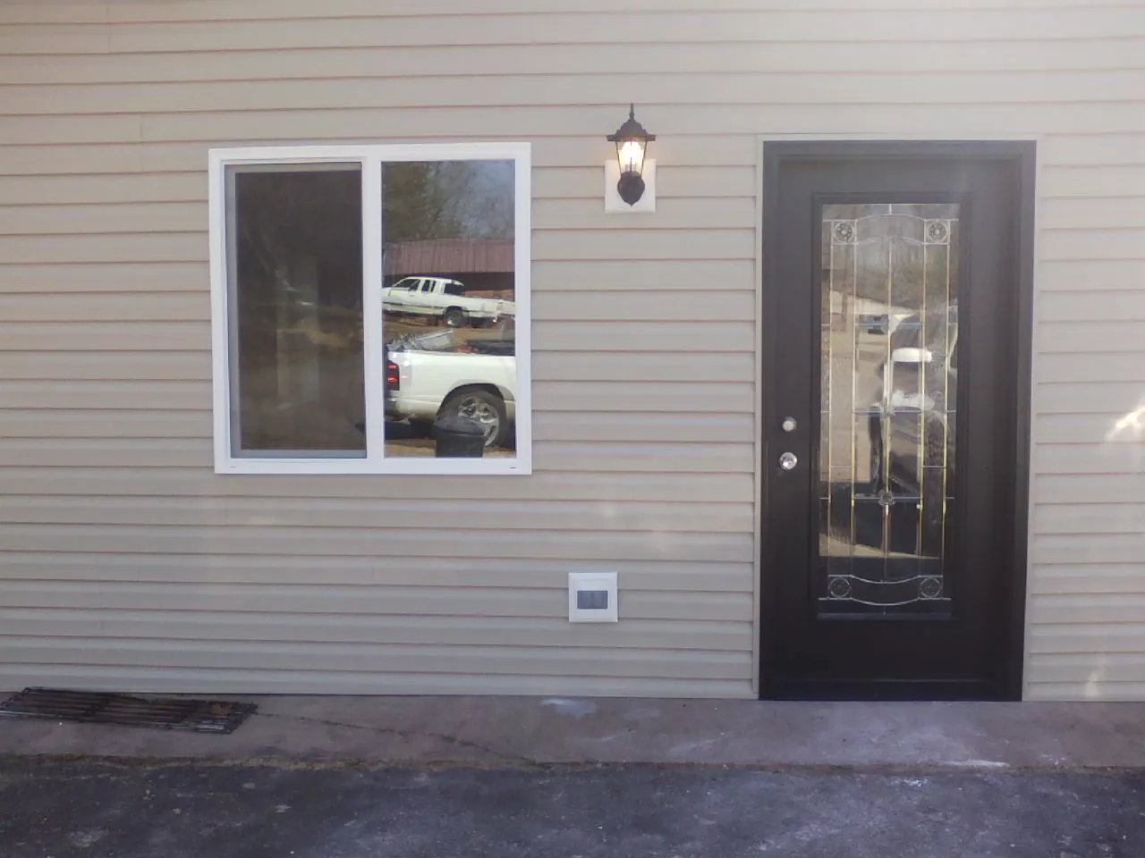 New siding, window and entry door on the side of an addition in Union Point