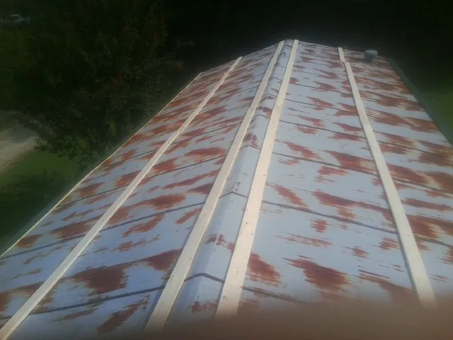 Rusted metal roof panels with new wood purlins before replacement — Storm Damage Roof Repair in Union Point by Roofing Brothers