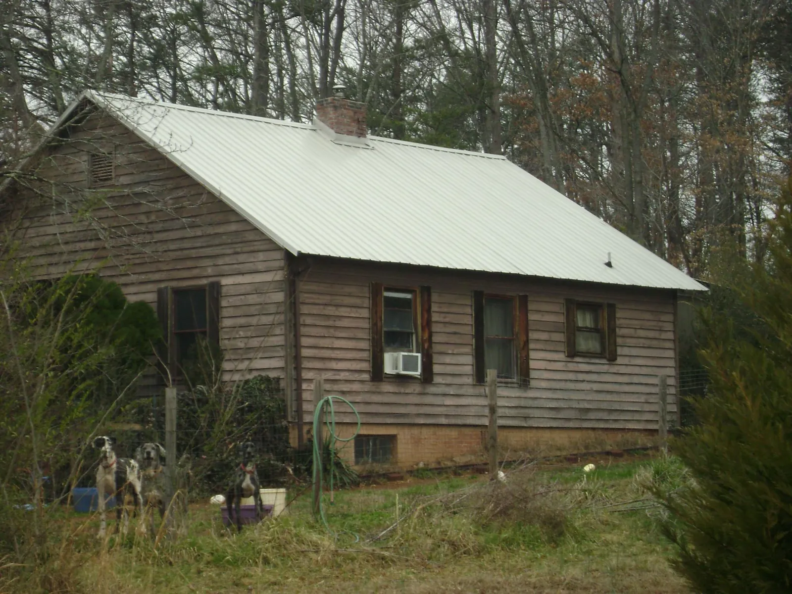 White metal roof on an old wood sided farmhouse, from a Metal Roof Installation job in Union Point